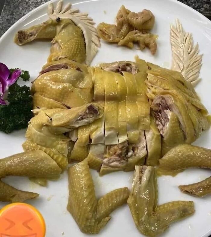 Sliced cooked chicken arranged on a plate to resemble a horse, an example of cursed food pics with unusual presentation.