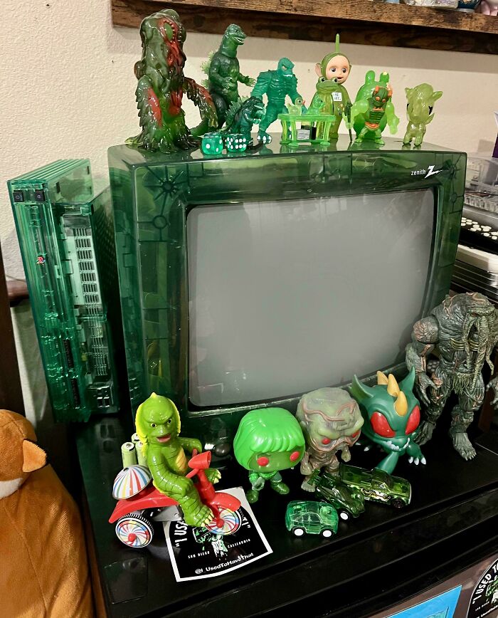 Vintage devices and green translucent toy figures displayed on an old Zenith CRT television set.