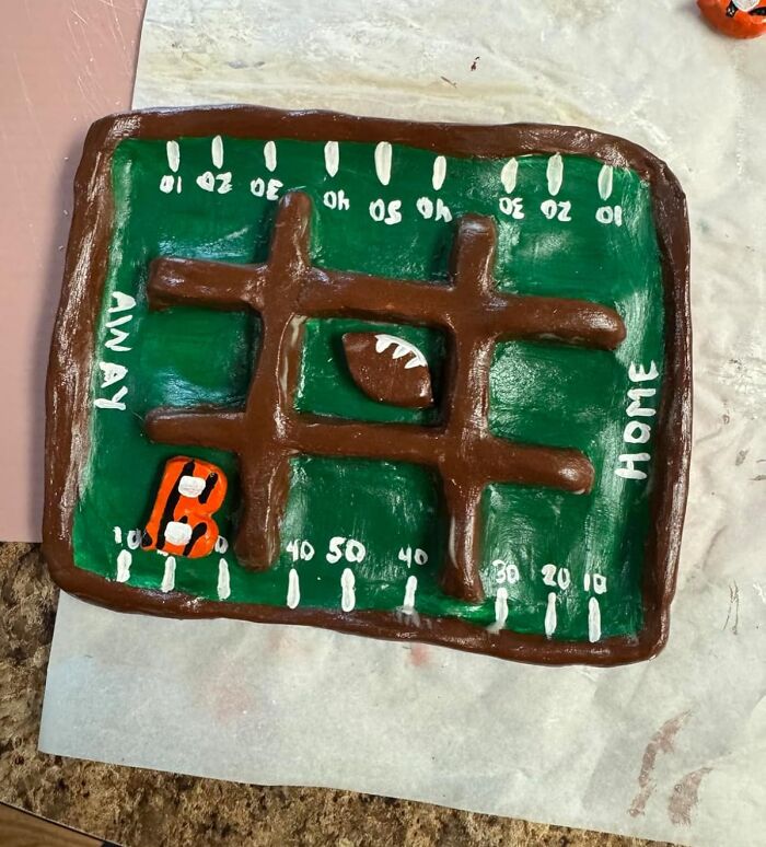 Handcrafted football field hobby project with clay, showcasing creativity and trying your best as the main skill needed.
