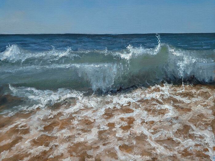 Waves crashing in the ocean near the sandy shore, showcasing the beauty of incredible ocean creatures habitat.