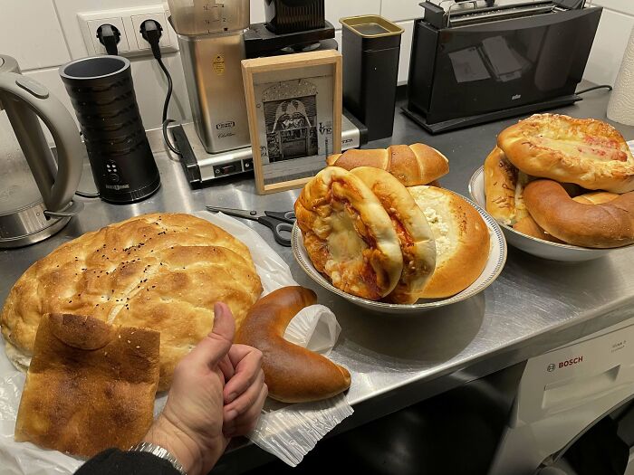 Various breads and baked goods displayed on a kitchen counter showing grocery costs where people live.