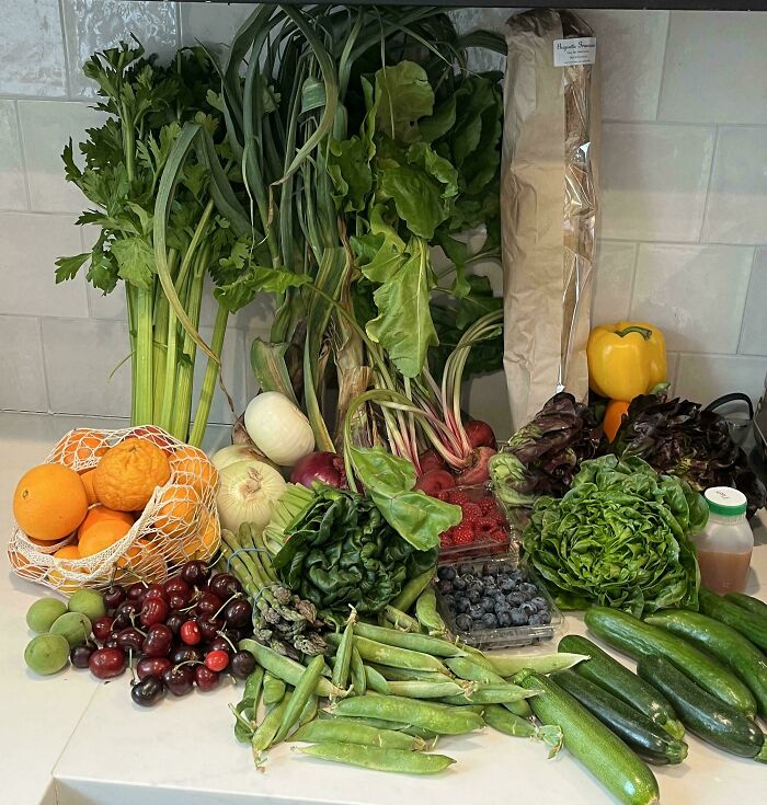 Fresh groceries including fruits, vegetables, and bread displayed to show grocery costs where people live.