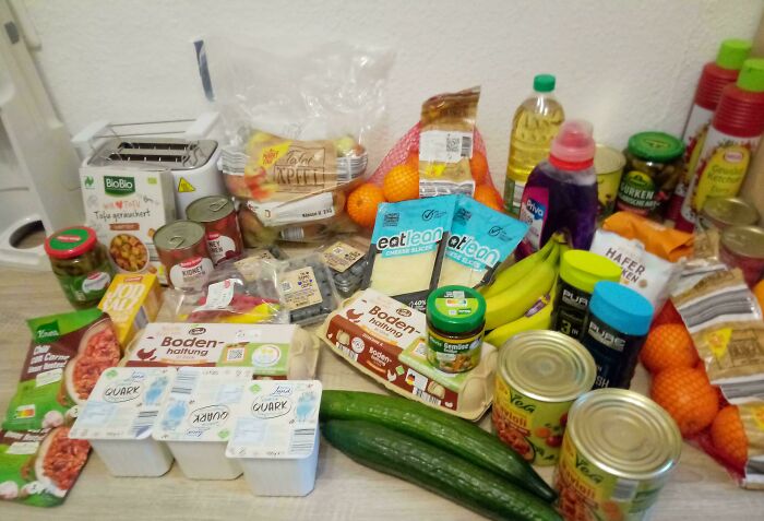 Groceries including fresh produce, dairy, canned goods, and snacks showing typical grocery costs where people live.