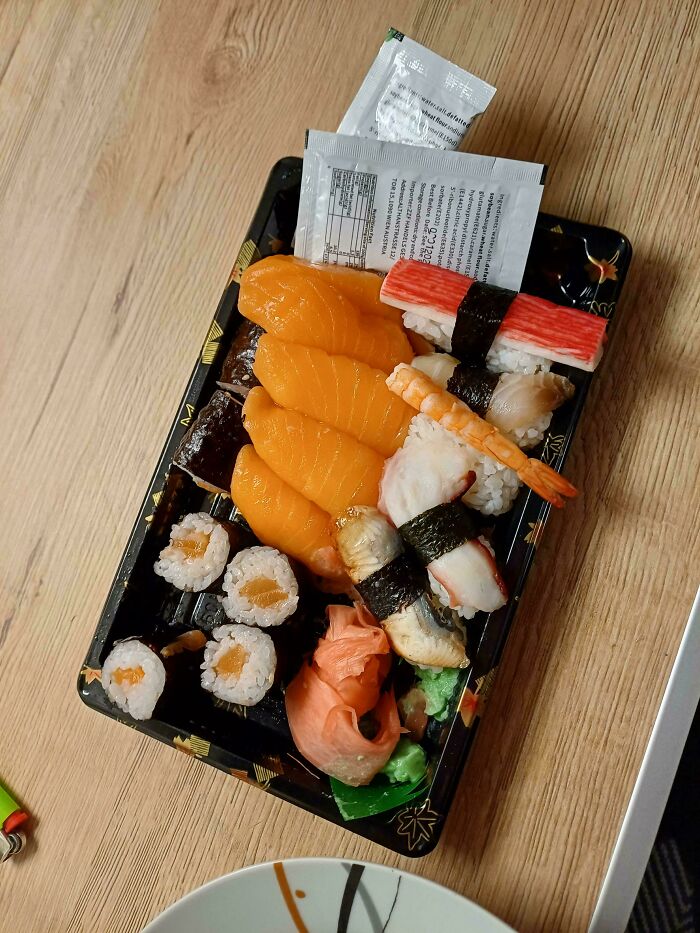 Tray of assorted sushi showing a grocery cost example where 80 people reveal how much groceries cost where they live