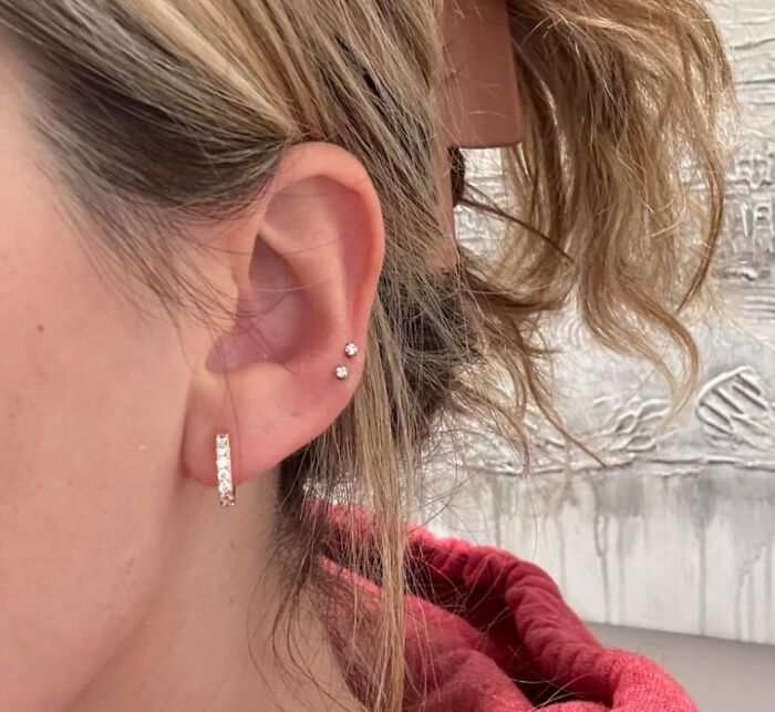 Close-up of a woman wearing delicate earrings, showcasing popular internet gold products found on Amazon trending everywhere.