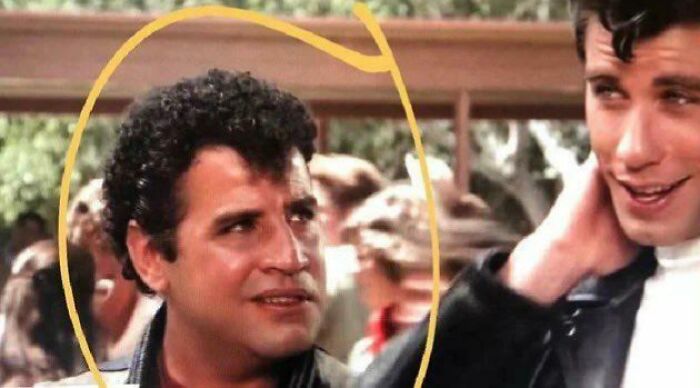 Two men in a vintage movie scene, one circled, illustrating questionable movie details mocked by cinephiles online.