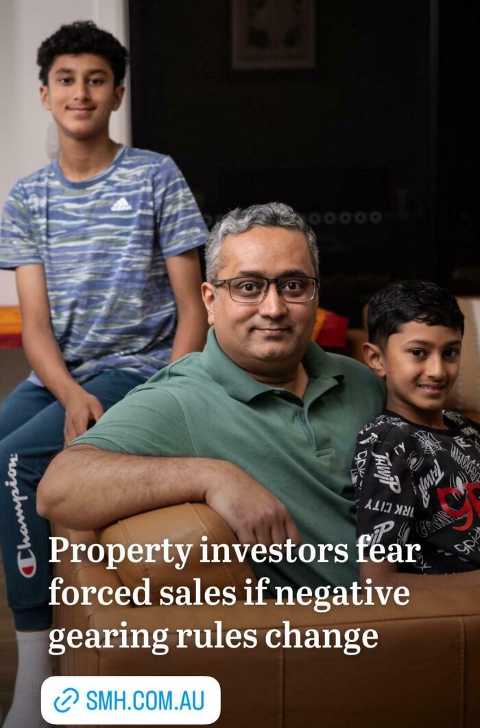 Man and two boys sitting in a living room, representing bad landlords and renters facing rental nightmares.