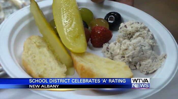 Plate with pickle slices, fruit, bread, and a creamy spread, illustrating cursed food pics that may unsettle viewers.