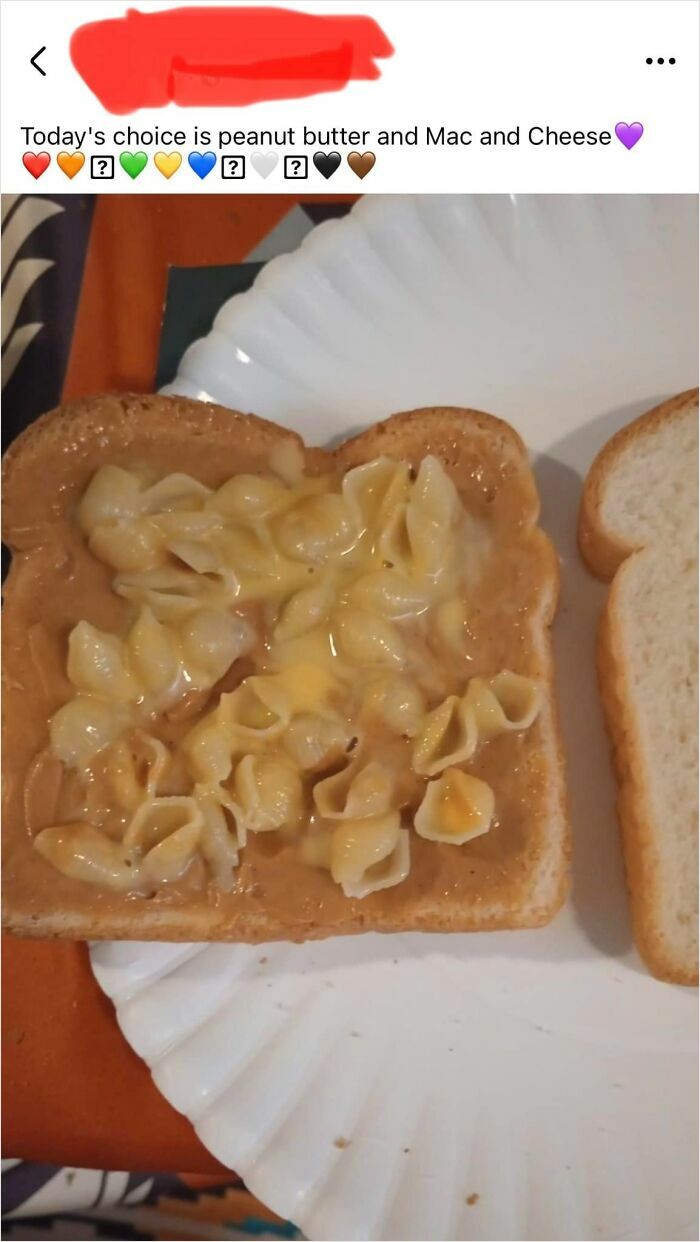 Slice of bread with peanut butter topped with macaroni and cheese shells on a paper plate, a cursed food pic.