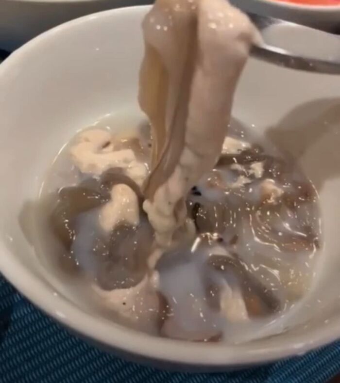Raw slimy seafood in a white bowl, an example of cursed food pics that might need a trigger warning.