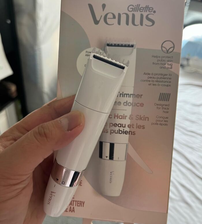Hand holding a Gillette Venus trimmer for sensitive hair and skin, a viral summer essential for heat wave prep.