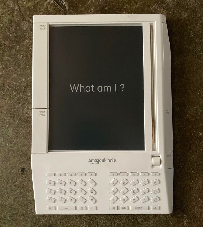 Vintage Amazon Kindle e-reader device with physical keyboard, illustrating retro technology in vintage devices collection.
