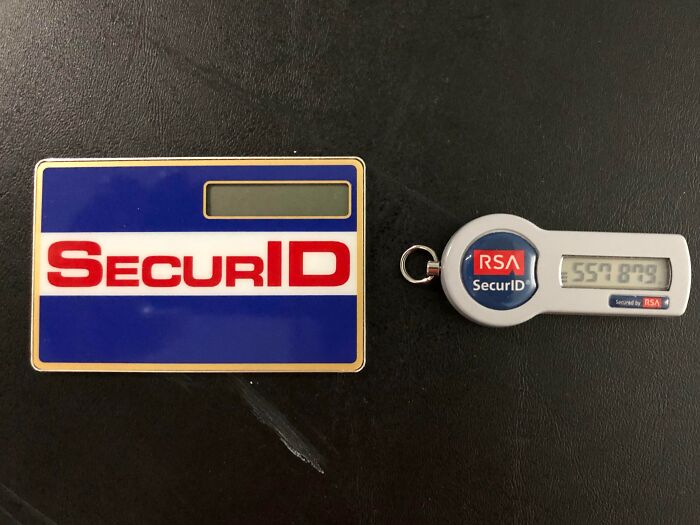 Two vintage security authentication devices with RSA SecurID branding displayed on a dark surface.