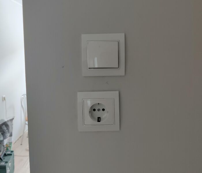 Electrical switch and power outlet installed incorrectly on wall, an example of infuriating landlord specials frustrating renters.