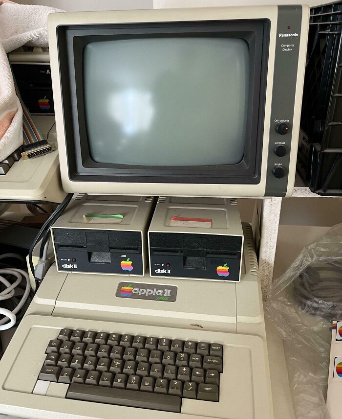 Vintage Apple II Plus computer with dual disk drives and Panasonic monitor showcasing vintage devices technology.