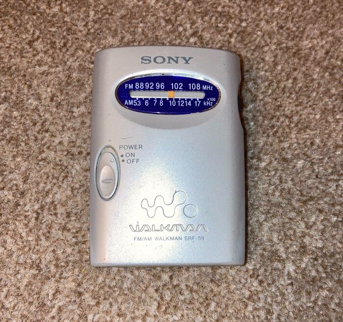 Vintage Sony FM AM Walkman radio placed on carpet showcasing classic technology device.