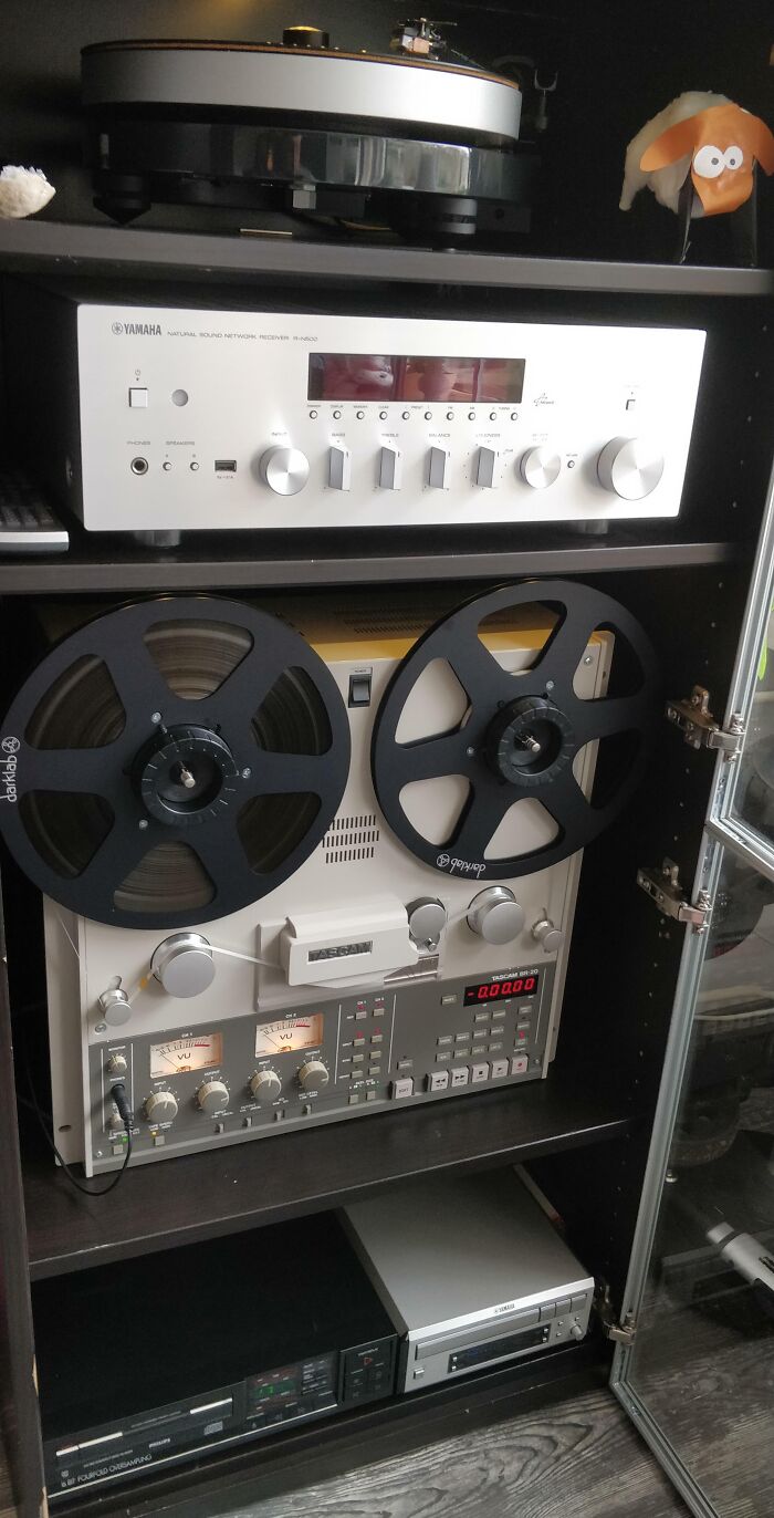 Vintage devices including reel-to-reel tape recorder and audio equipment showcasing technology moving at the speed of light.