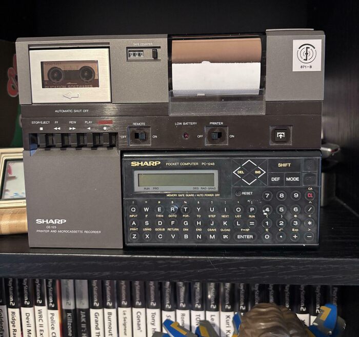 Vintage Sharp pocket computer and microcassette recorder, showcasing retro technology and vintage devices from past decades.