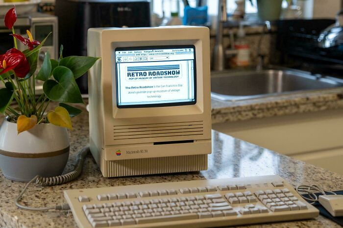 Vintage device Apple Macintosh SE/30 desktop computer on kitchen counter illustrating vintage technology progress