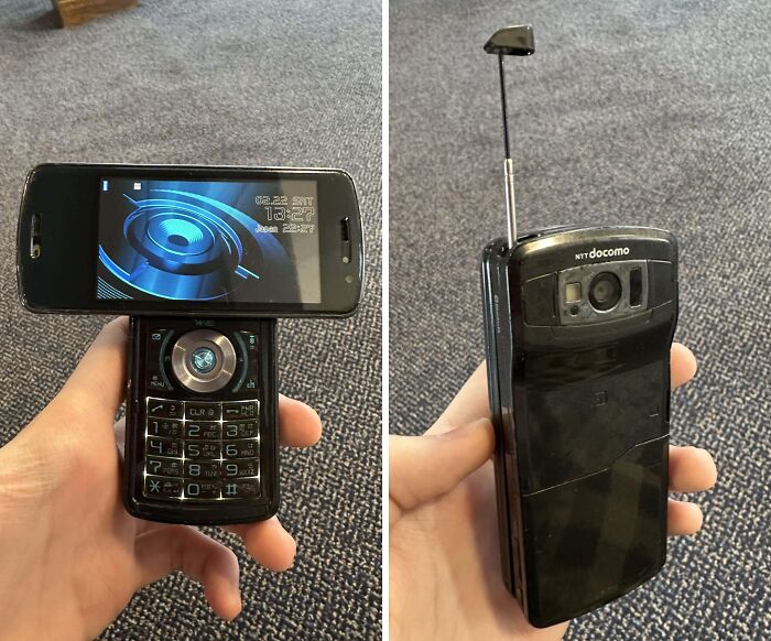 Vintage mobile phone with swivel screen and antenna held in hand, showcasing classic technology and design features.