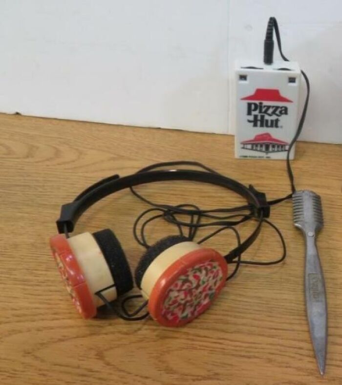 Vintage device featuring novelty headphones with pizza-themed earpieces and a Pizza Hut branded microphone attachment.