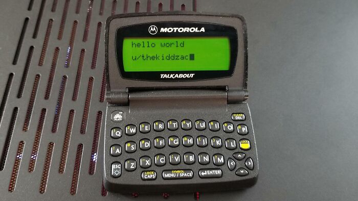 Vintage Motorola Talkabout device with physical QWERTY keyboard and green screen, showcasing vintage devices technology evolution.