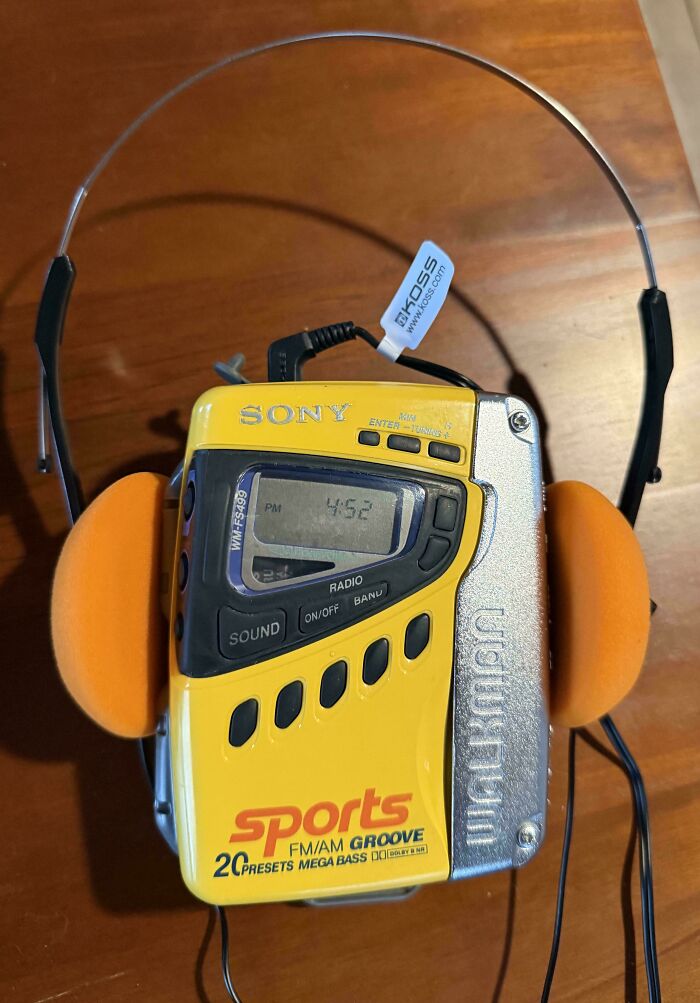 Vintage Sony Walkman with attached orange foam headphones, showcasing old portable technology and vintage devices.