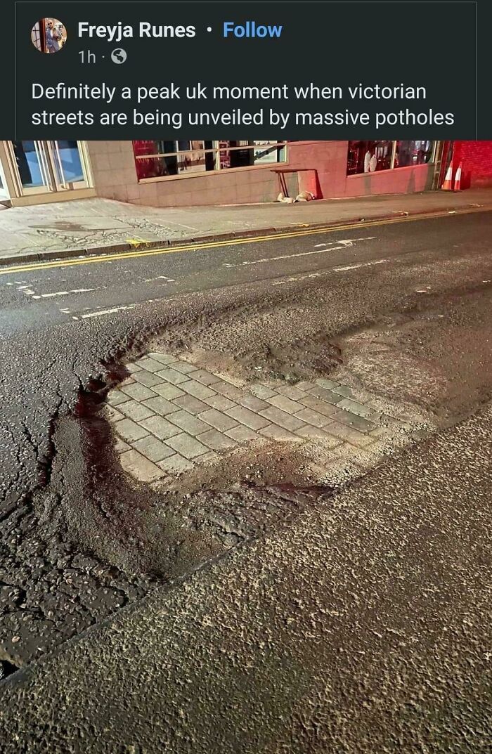 Massive pothole revealing Victorian street bricks in a UK road, highlighting typical Great British memes humor.