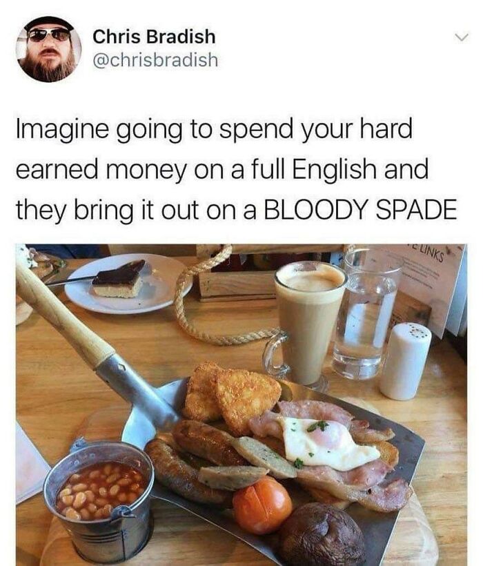 Meme showing a full English breakfast served on a gardening spade with beans, sausage, and egg on a table.