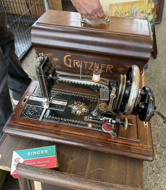Vintage Gritzner sewing machine with ornate details, showcasing classic design among vintage devices illustrating technology evolution.