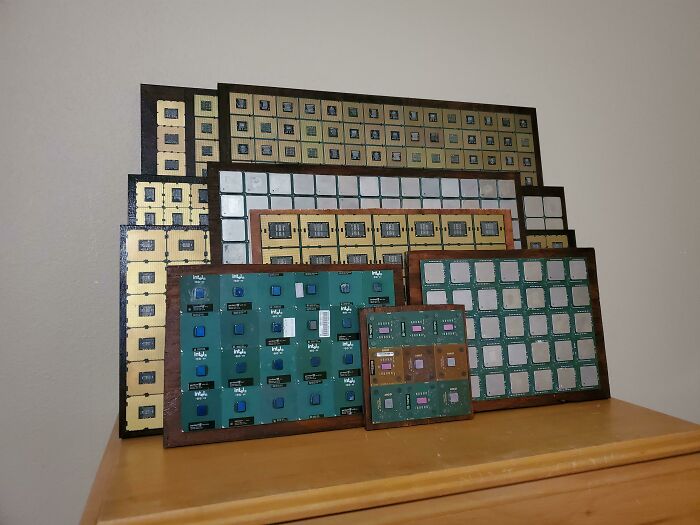 Vintage electronic circuit boards displayed on a wooden surface showcasing vintage devices and technology evolution.