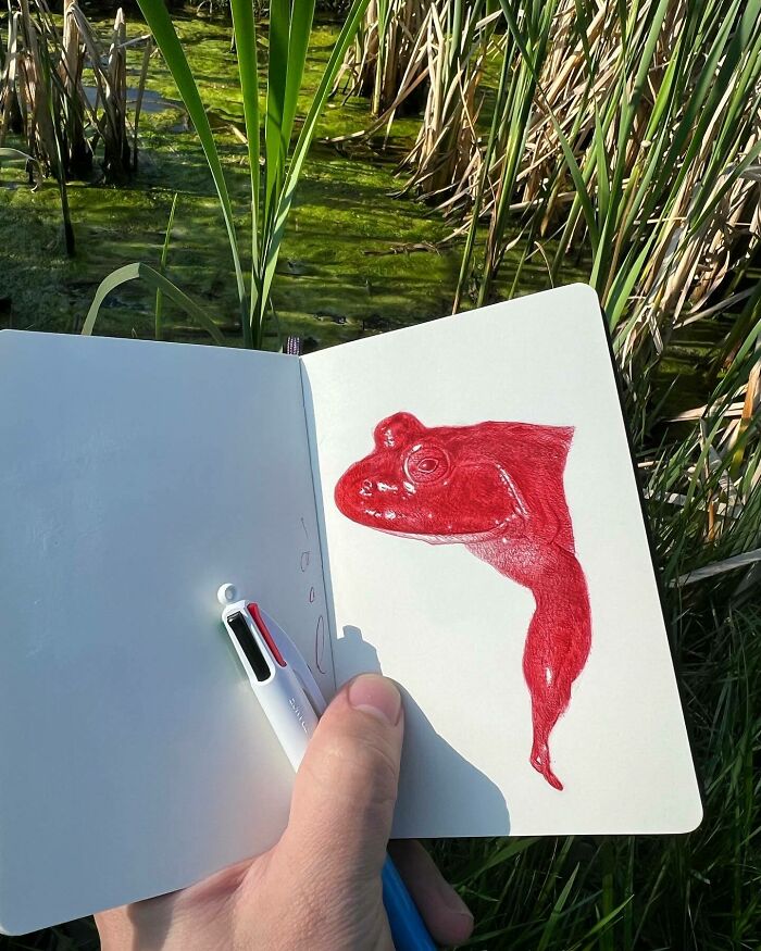 Hand holding tiny sketchbook with red frog drawing, capturing big emotions in everyday moments by artist Nicolas V. Sanchez.