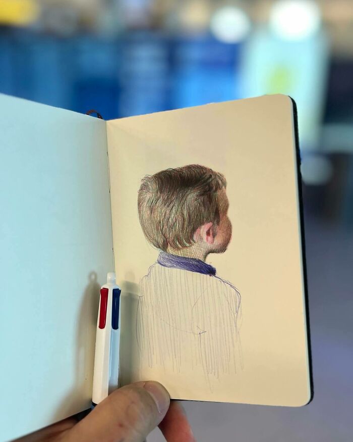 Hand holding a tiny sketchbook with a colored pencil drawing of a boy, showcasing big emotions in everyday moments.