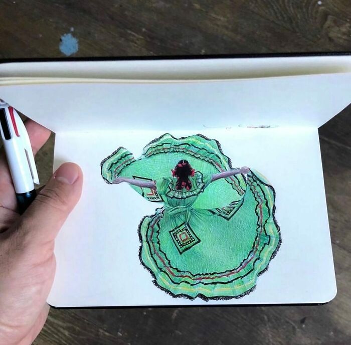 Hand holding a tiny sketchbook featuring detailed drawing, showcasing big emotions in everyday moments by artist Nicolas V. Sanchez.