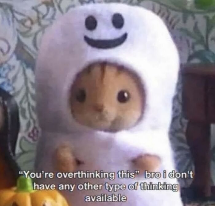 Cute cat dressed in a ghost costume with a relatable meme about overthinking from popular relatable memes content.