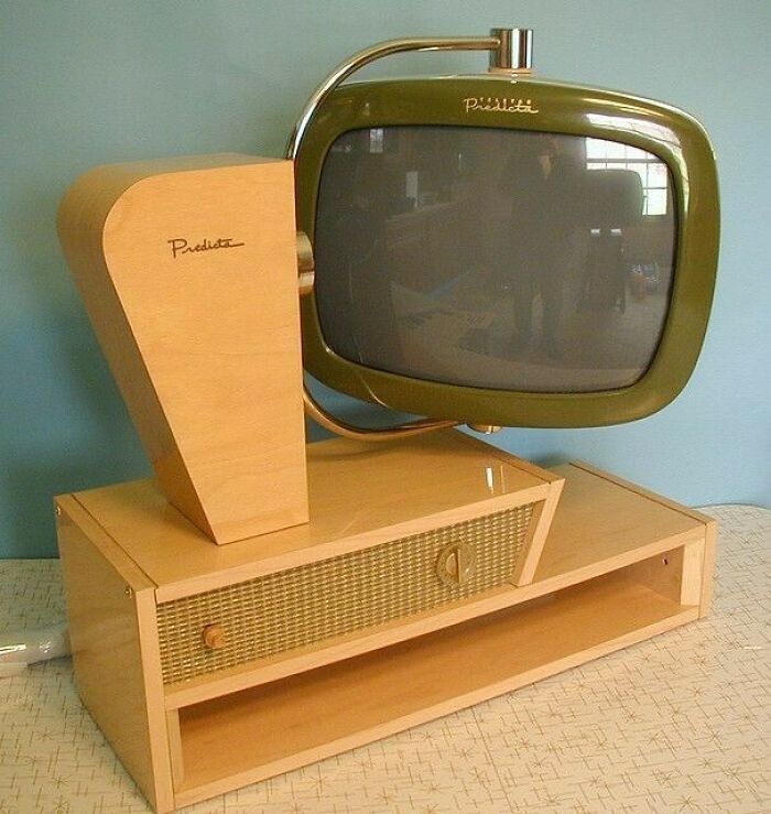 Vintage device featuring a mid-century modern television with wooden casing, showcasing retro technology design style.