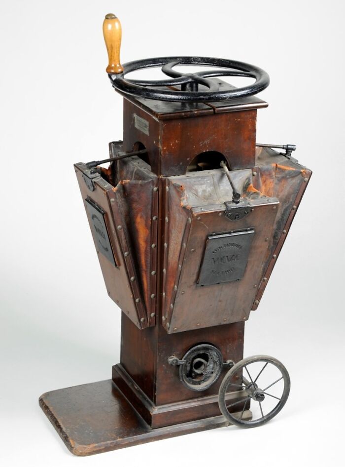 Vintage device with wooden handle and metal parts, showcasing early technology that highlights the evolution of vintage devices.