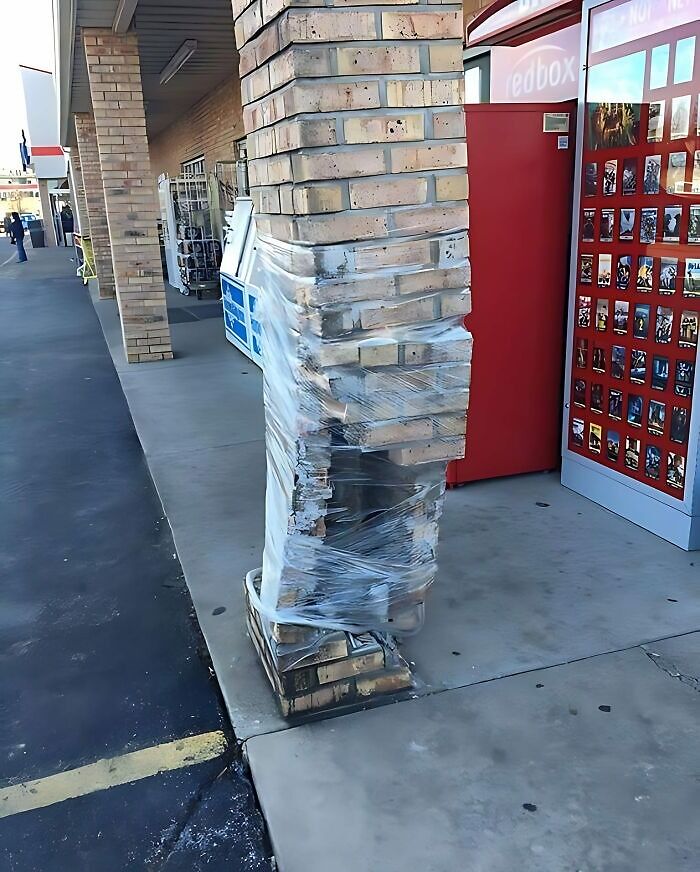 Brick pillar wrapped in plastic with uneven and damaged brickwork, showing a renovation fail and saving mistake.