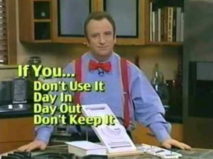 Man wearing a red bow tie and suspenders in a kitchen with text about not keeping unused items, showing cringey nineties fashions.