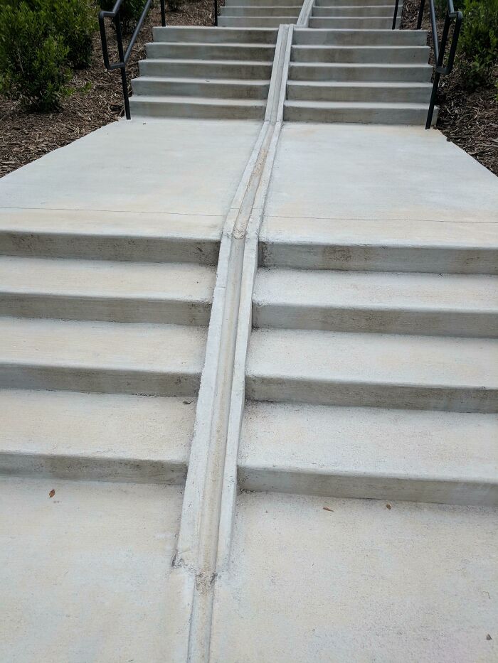 Concrete stairs with a built-in narrow ramp in the middle as a clever way people solved overlooked accessibility issues.