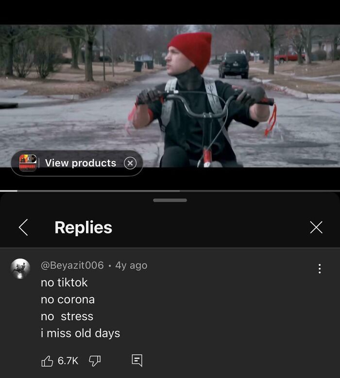 Person wearing a red beanie riding a bike on an empty street, reflecting rose tinted tolerance and nostalgia online.