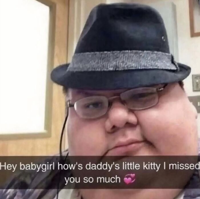 Man wearing glasses and a fedora hat posing with a cringey Instagram caption expressing affection in an awkward selfie.