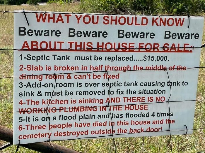 Warning sign listing severe issues of a house for sale including septic tank, broken slab, sinking kitchen, and past deaths on property.