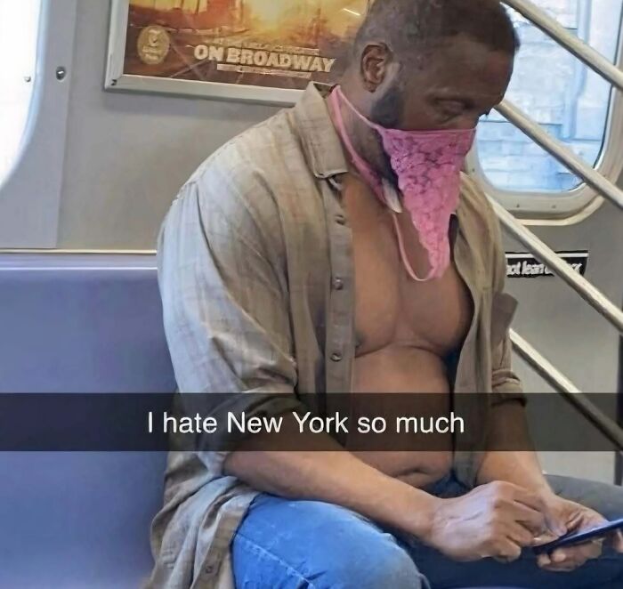 Man on subway wearing unconventional face covering and unbuttoned shirt in a cringey picture shared on Instagram account.