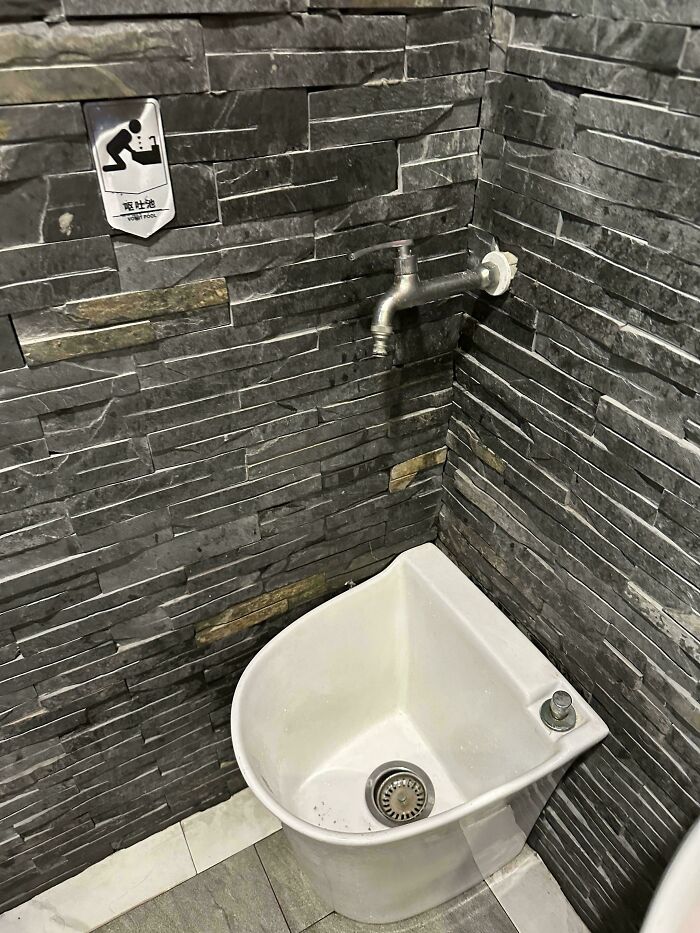 Small washing basin with a faucet mounted on a tiled wall showing clever solutions for overlooked issues.