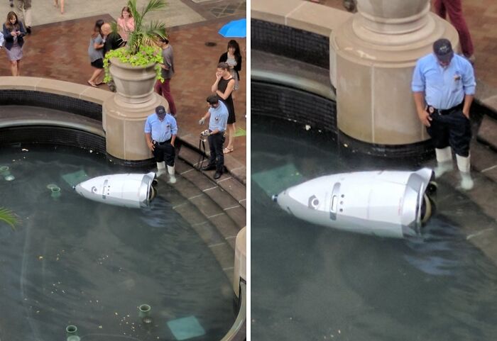 Security guards stand by a drone submerged in water inside a fountain, showcasing one of the tech fails.