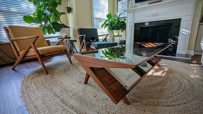 Mid-century designs featuring a vintage wooden coffee table and stylish armchairs in a bright living room setting