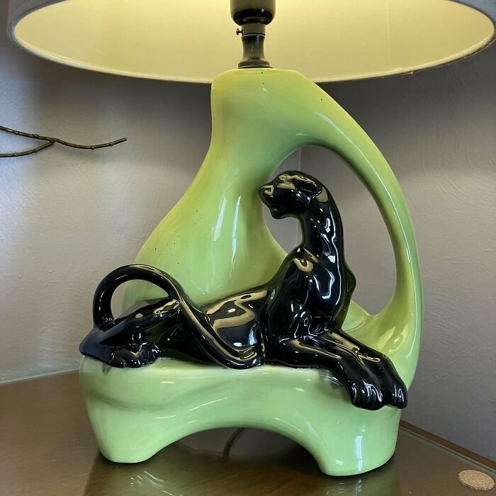 Mid-century design ceramic lamp featuring a sleek black panther figure with vintage charm and glossy green base.