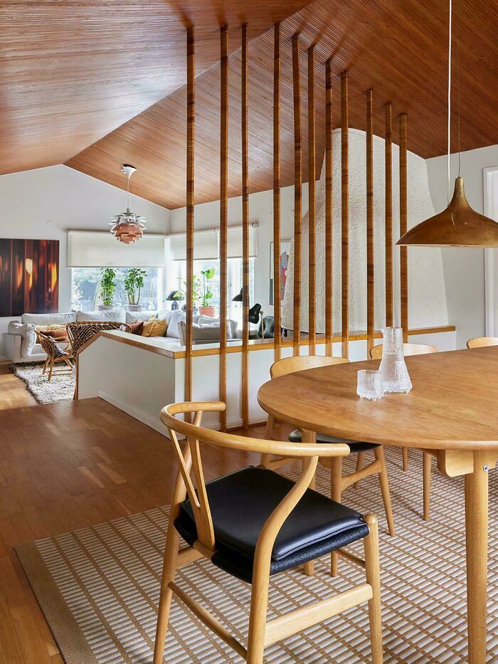 Mid-century design dining area with wooden furniture and vintage charm in a bright, open living space.