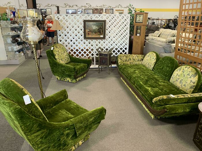 Vintage mid-century designs featuring green velvet sofa and armchairs in a cozy living room setting
